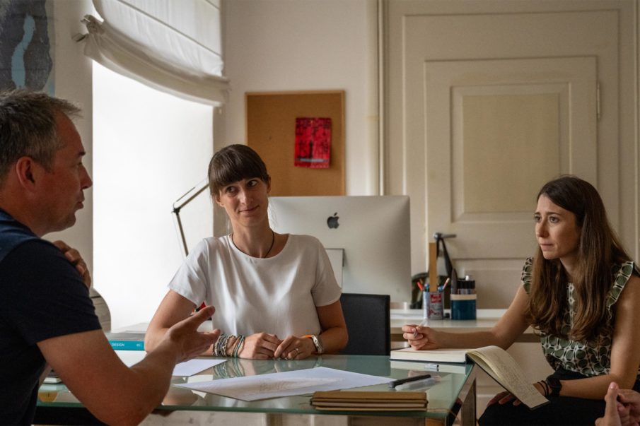 Employees at By Stinessen sitting in the office and discussing.